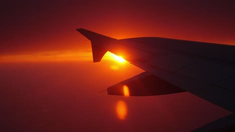 Window-point-of-view-of-the-sunrise-in-a-plane.-Location-Paris-early-morning.-Wi